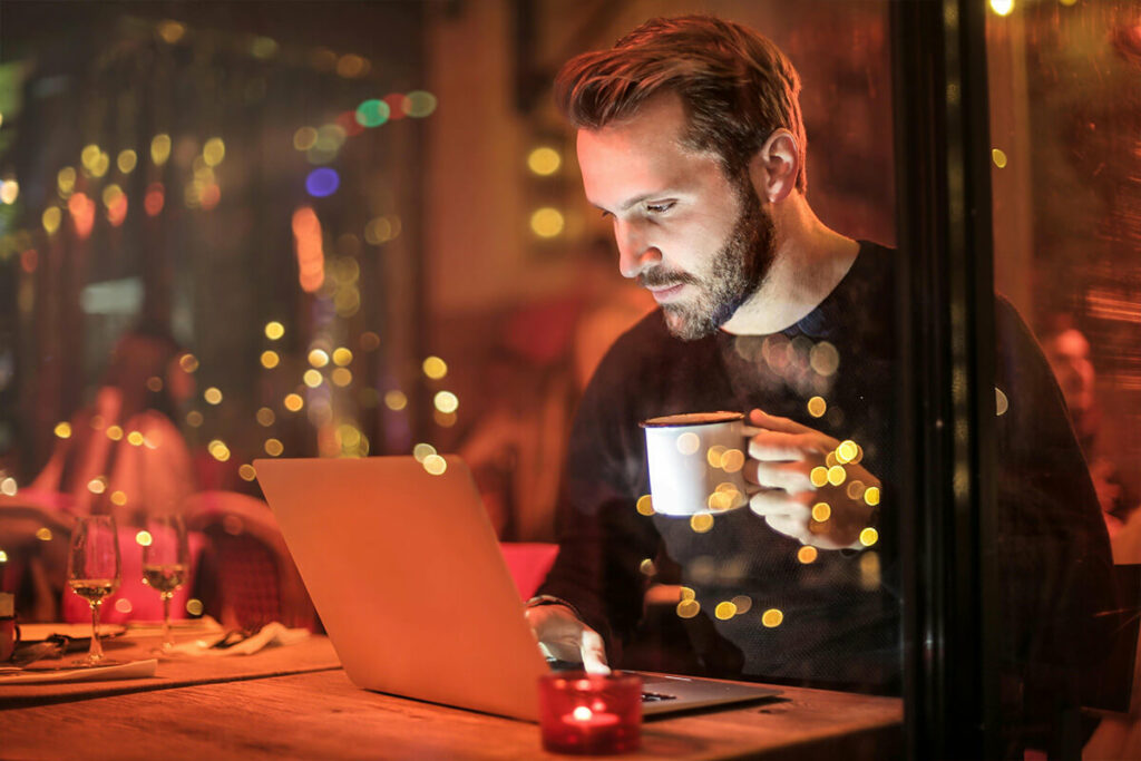 Man reading about moving services while having coffee